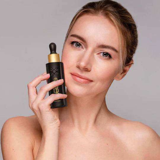 Woman holding sleep and renew serum by Emani